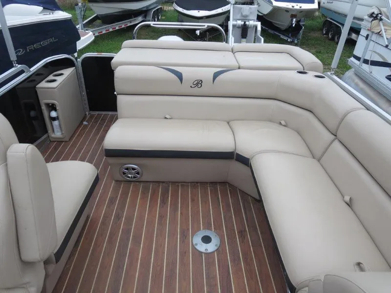Slide: The Image of Luxurious seating on 2015 Berkshire 230CL STS pontoon boat with wood-style flooring. - 8