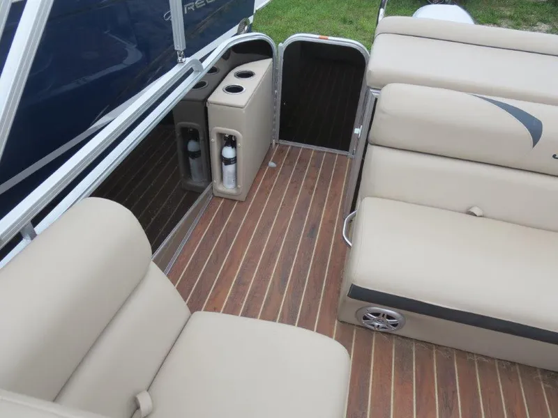 Slide: The Image of Interior of 2015 Berkshire 230CL STS pontoon boat with beige seating and wood flooring. - 9