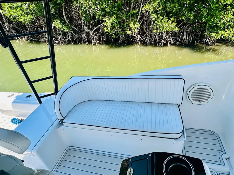 Slide: The Image of 2000 Luhrs Tournament 320 Open boat seating area with white cushioned bench. - 12