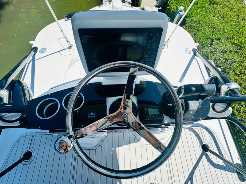 Slide: The Image of 2000 Luhrs Tournament 320 Open boat helm with steering wheel and navigation equipment. - 22