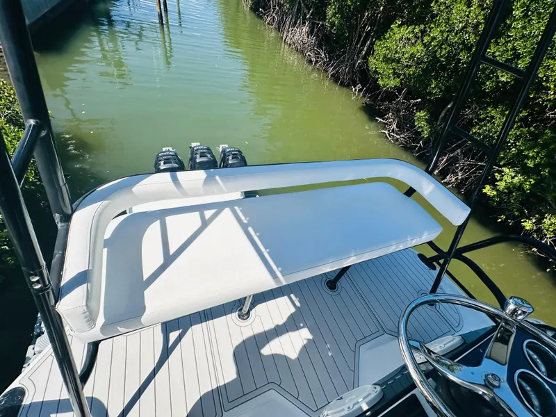 Slide: The Image of 2000 Luhrs Tournament 320 Open boat, rear deck view with white seating and water backdrop. - 23