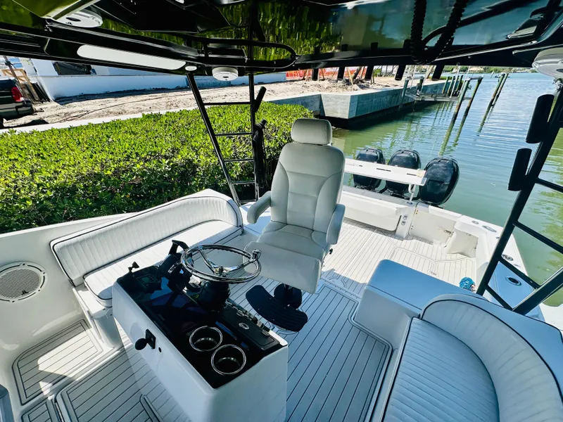 Slide: The Image of 2000 Luhrs Tournament 320 Open boat interior with helm, seating, and twin outboard motors. - 5