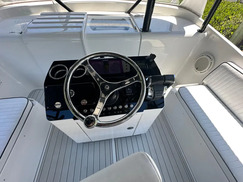 Slide: The Image of 2000 Luhrs Tournament 320 Open boat helm with steering wheel and seating. - 6