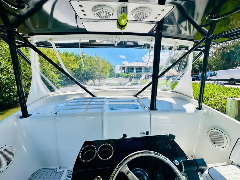 Slide: The Image of 2000 Luhrs Tournament 320 Open boat helm with clear canopy and scenic view. - 8