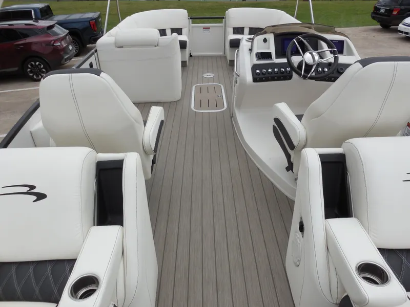 Slide: The Image of 2019 Bennington QX 25 QXFBA pontoon boat interior with white seating and modern dashboard. - 12