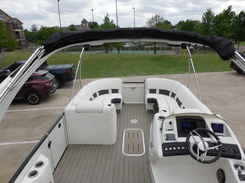 Slide: The Image of 2019 Bennington QX 25 QXFBA pontoon boat with spacious seating and modern dashboard. - 13