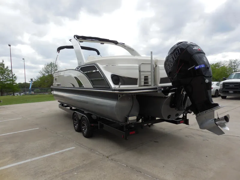 Slide: The Image of 2019 Bennington QX 25 QXFBA pontoon boat on trailer with outboard motor. - 4