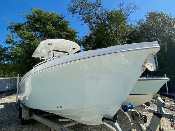 The Image of 2024 Parker 2600 CC boat on trailer, side view, outdoors. - 1