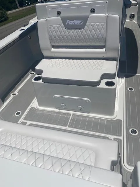 Slide: The Image of 2024 Parker 2900 CC boat interior with white cushioned seating and diamond stitching. - 4