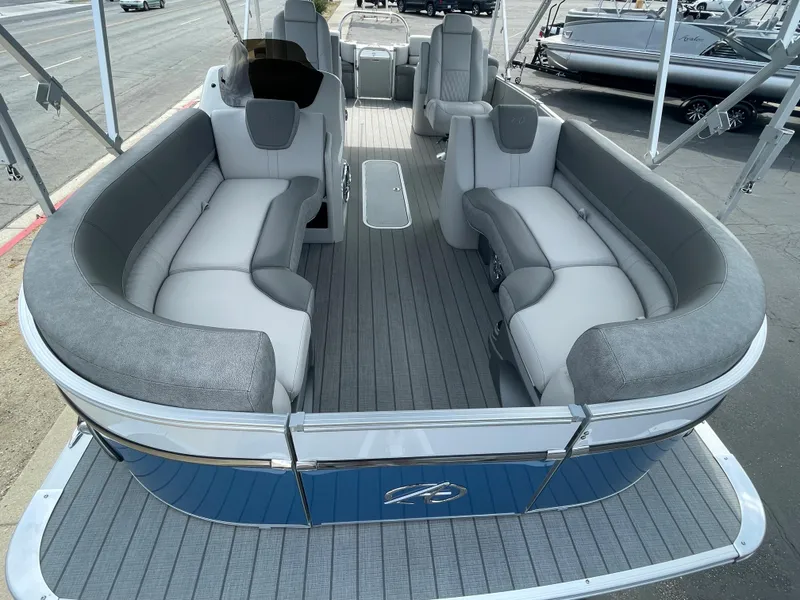 Slide: The Image of 2025 Avalon 2385 Catalina QLS pontoon boat, blue exterior, displayed indoors. - 2