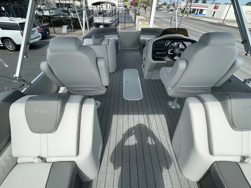 Slide: The Image of Interior of 2025 Avalon 2385 Catalina QLS boat with luxurious seating and modern dashboard. - 6