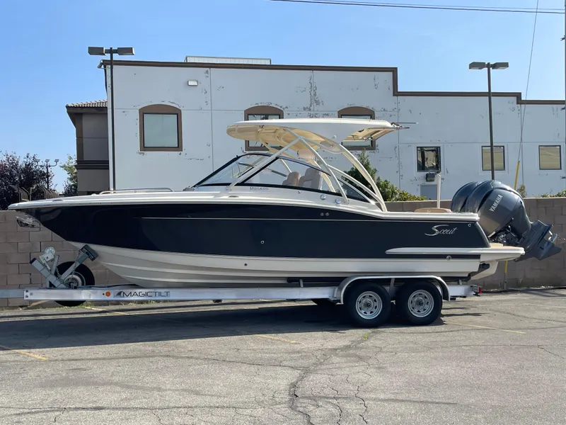 Slide: The Image of 2024 Scout 255 Dorado boat on a trailer in a parking lot. - 11