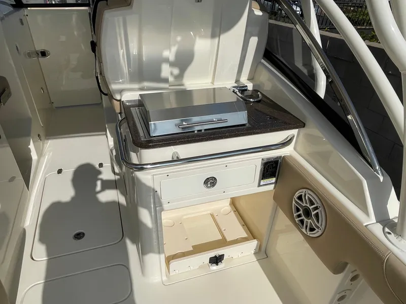 Slide: The Image of 2024 Scout 255 Dorado boat interior with grill and storage compartments. - 6