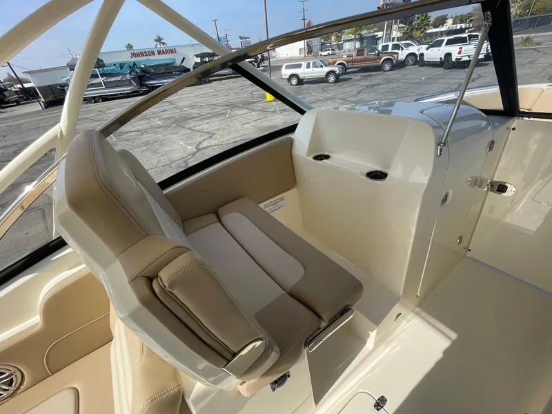 Slide: The Image of 2024 Scout 255 Dorado boat interior with beige seating and dashboard. - 8