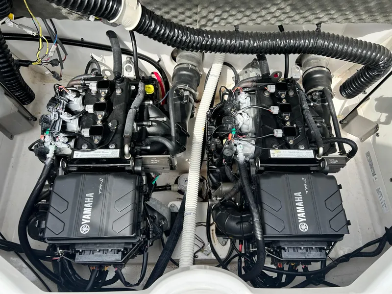 Slide: The Image of 2019 Yamaha Boats AR 210 twin engines in engine compartment. - 12