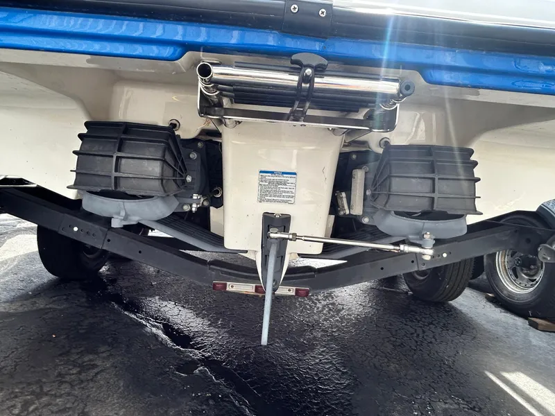 Slide: The Image of 2019 Yamaha Boats AR 210 rear view showing dual jet drives and trailer. - 13