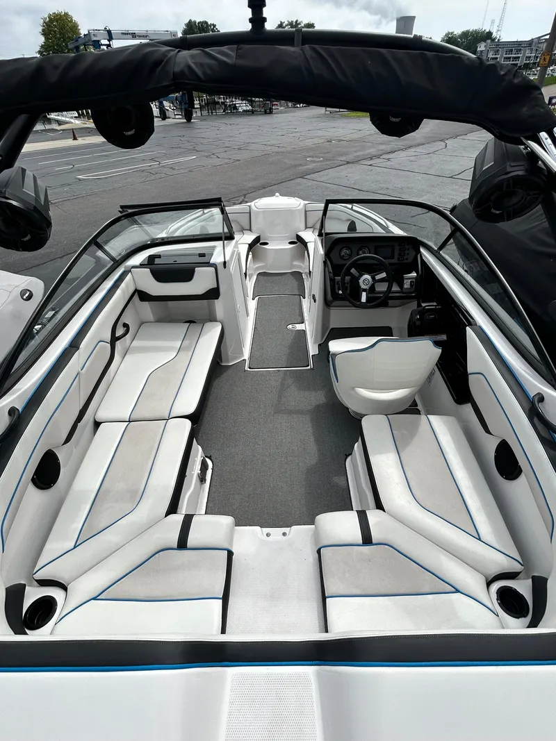 Slide: The Image of 2019 Yamaha Boats AR 210 interior with spacious seating and modern dashboard. - 5