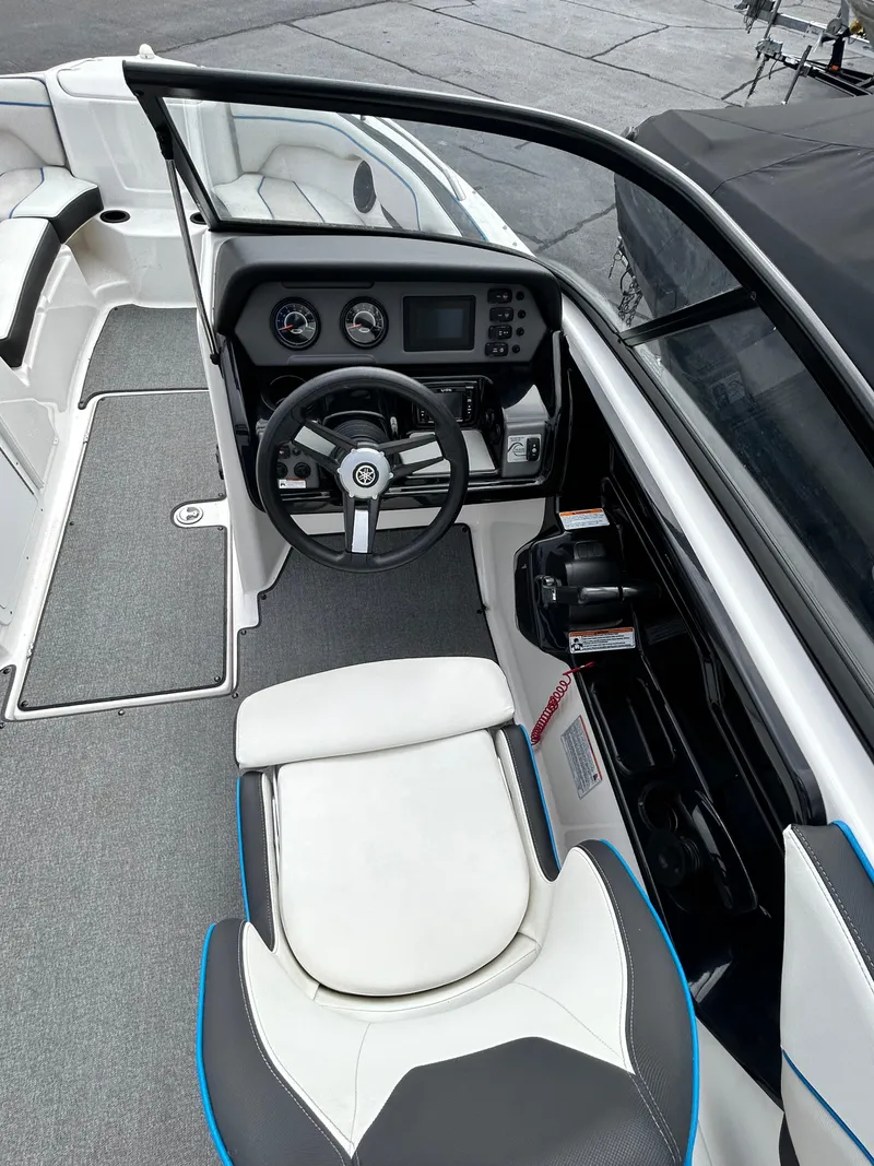Slide: The Image of 2019 Yamaha Boats AR 210 cockpit with steering wheel and control panel. - 7
