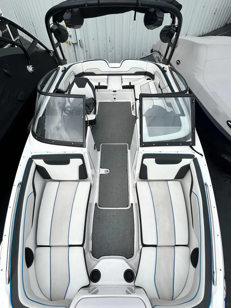 Slide: The Image of 2019 Yamaha Boats AR 210 interior view with seating and steering console. - 9