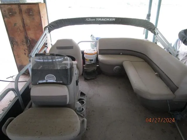 Slide: The Image of 2022 Sun Tracker Bass Buggy pontoon boat interior with seating and console. - 4