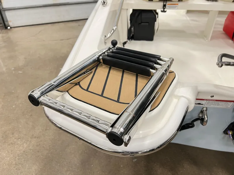 Slide: The Image of 2024 Boston Whaler 130 SPT boat with a folded stainless steel swim ladder. - 6