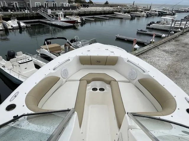 Slide: The Image of 2019 Key West 203 DFS boat docked at a marina, featuring spacious seating and cup holders. - 12