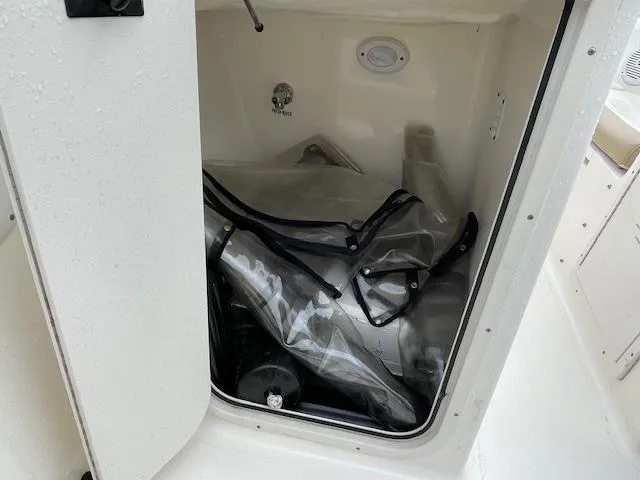 Slide: The Image of Storage compartment of a 2019 Key West 203 DFS boat with equipment inside. - 13