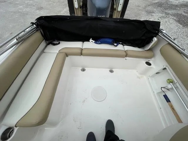 Slide: The Image of 2019 Key West 203 DFS boat interior with beige seating and storage compartments. - 14