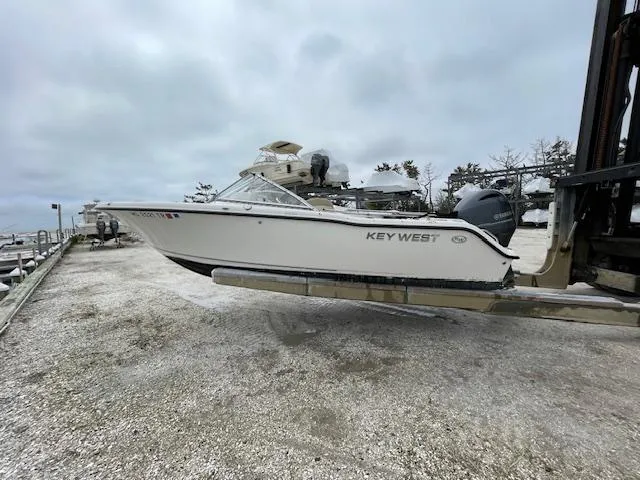 Slide: The Image of 2019 Key West 203 DFS boat on a lift at a marina. - 2
