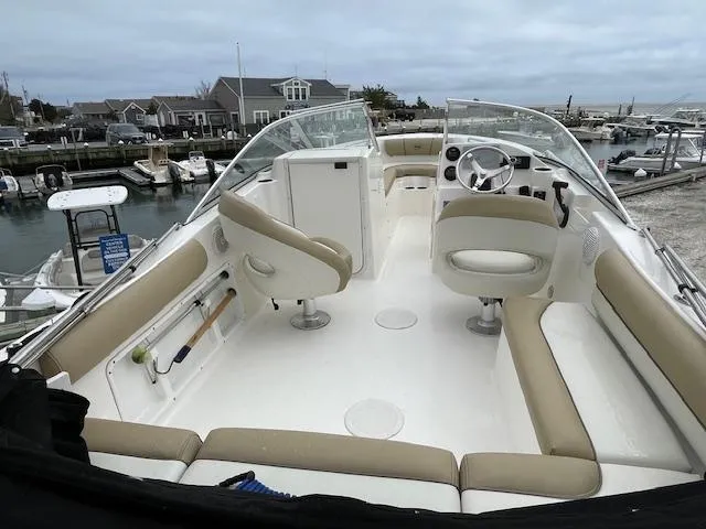 Slide: The Image of 2019 Key West 203 DFS boat with beige seating at a marina. - 6