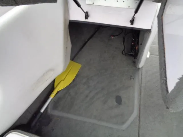 Slide: The Image of 2005 Nautique Air 226 interior storage compartment with yellow paddle. - 11