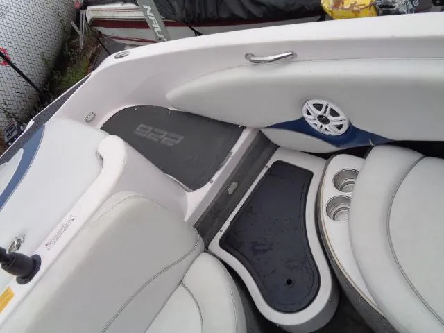 Slide: The Image of 2005 Nautique Air 226 boat interior with white seating and cup holders. - 15