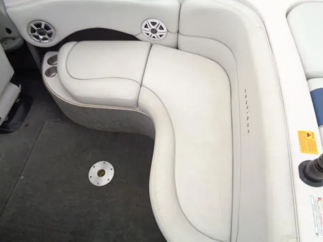Slide: The Image of 2005 Nautique Air 226 boat interior with white cushioned seating and cup holders. - 21
