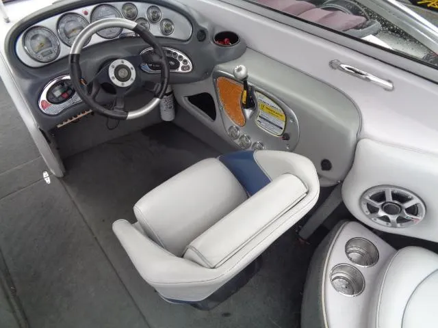 Slide: The Image of 2005 Nautique Air 226 boat cockpit with steering wheel, gauges, and captain's chair. - 22
