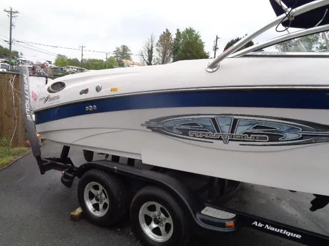 Slide: The Image of 2005 Nautique Air 226 boat on trailer, side view with logo and blue stripe. - 7