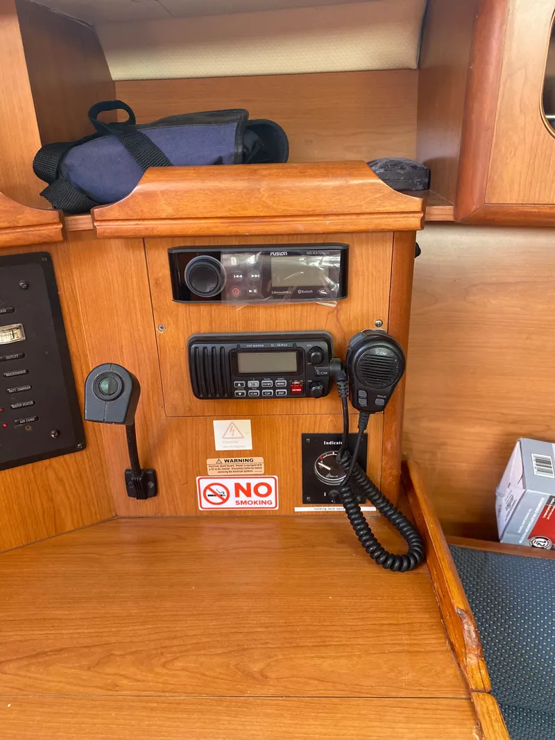 Slide: The Image of 2009 Hunter 31-2 boat interior with communication equipment and wooden cabinetry. - 11