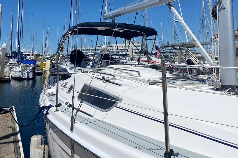 Slide: The Image of 2009 Hunter 31-2 sailboat docked at a marina on a sunny day. - 16