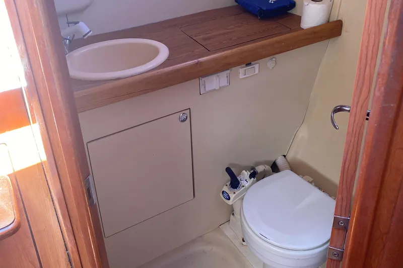 Slide: The Image of Compact bathroom in a 2009 Hunter 31-2 sailboat with sink and toilet. - 20