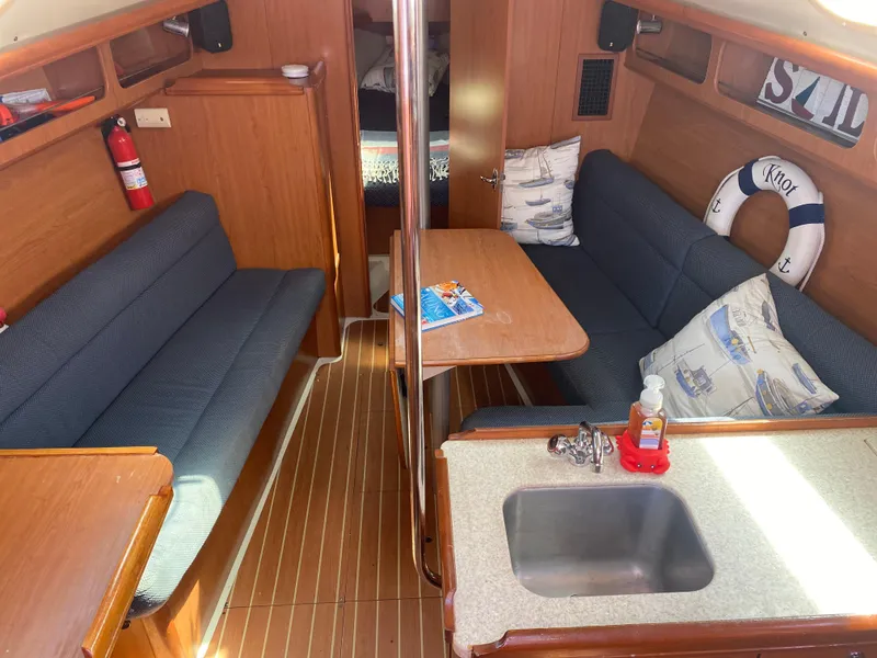 Slide: The Image of Interior of a 2009 Hunter 31-2 sailboat with seating, table, and kitchenette. - 5