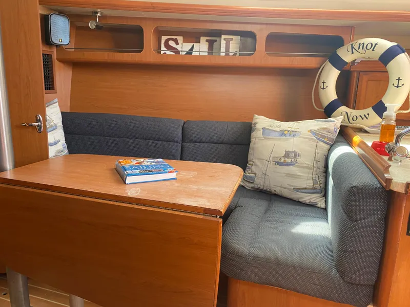 Slide: The Image of Cozy interior of a 2009 Hunter 31-2 sailboat with a dining area. - 8
