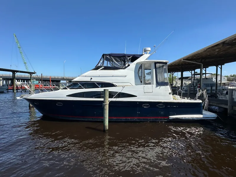 Slide: The Image of 2002 Carver 444 Cockpit Motor Yacht docked in marina. - 0