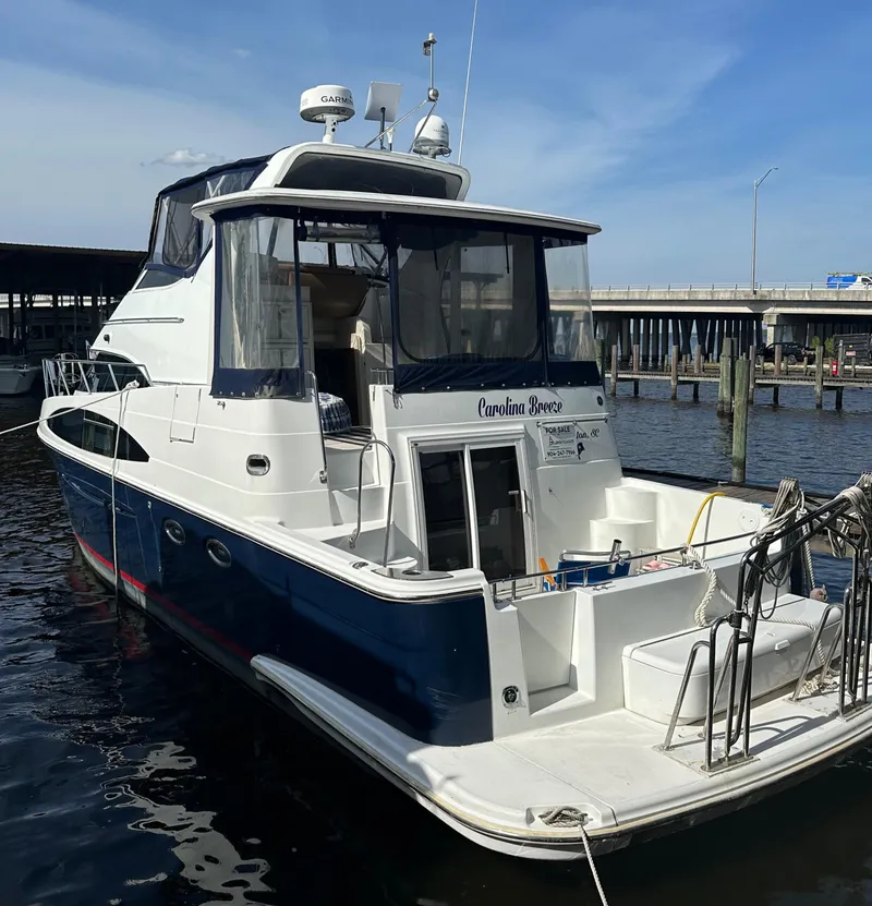Slide: The Image of 2002 Carver 444 Cockpit Motor Yacht docked at marina. - 1