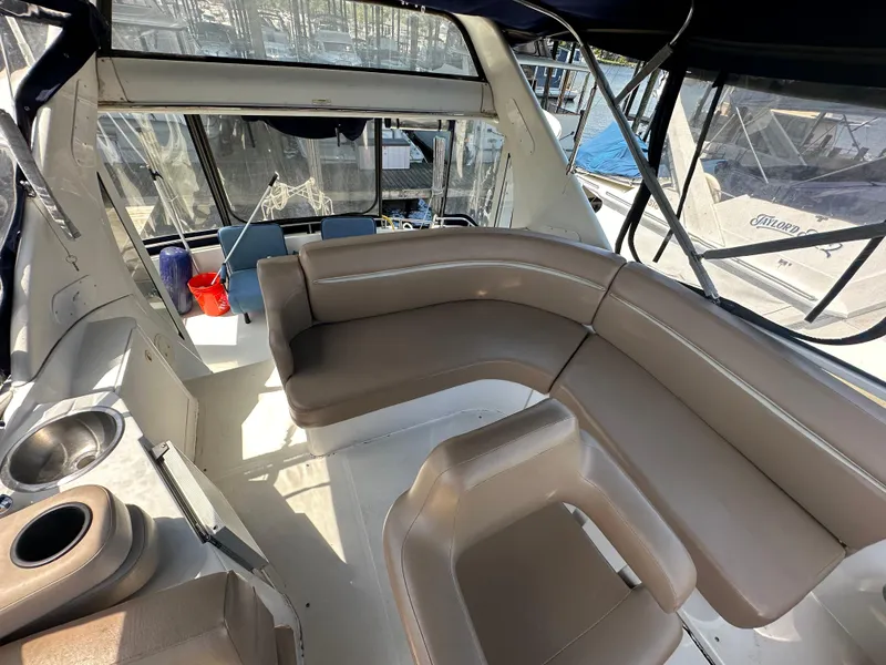 Slide: The Image of Interior of 2002 Carver 444 Cockpit Motor Yacht with beige seating and helm station. - 11