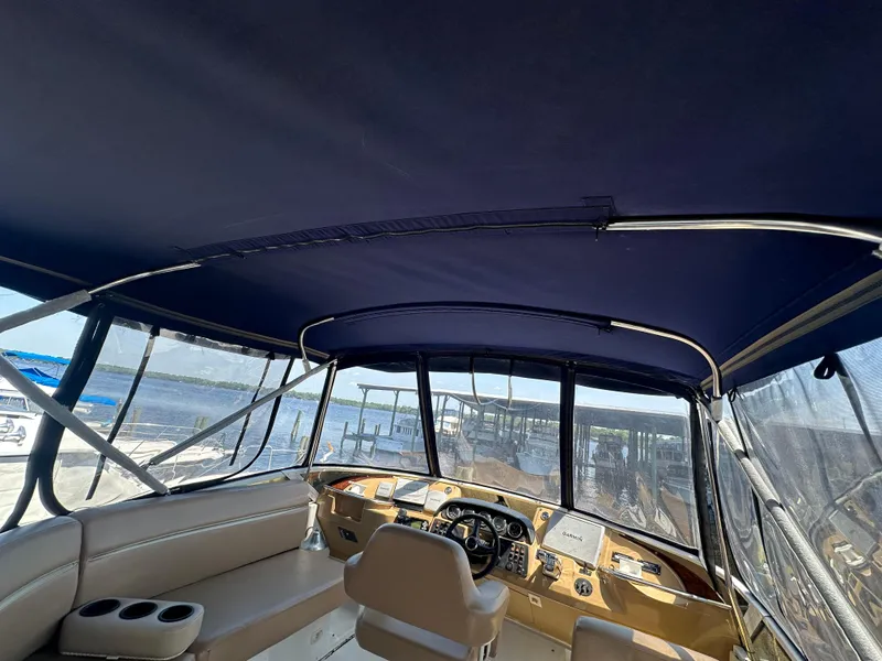 Slide: The Image of Interior view of 2002 Carver 444 Cockpit Motor Yacht helm station with seating and controls. - 13