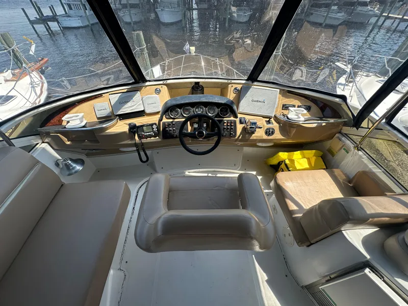 Slide: The Image of 2002 Carver 444 Cockpit Motor Yacht helm with panoramic marina view. - 14