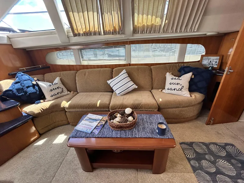 Slide: The Image of Interior of a 2002 Carver 444 Cockpit Motor Yacht with cozy seating area. - 15