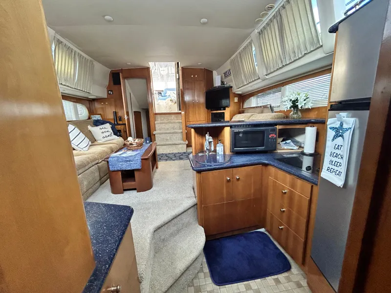 Slide: The Image of Interior of 2002 Carver 444 Cockpit Motor Yacht with kitchen and seating area. - 17