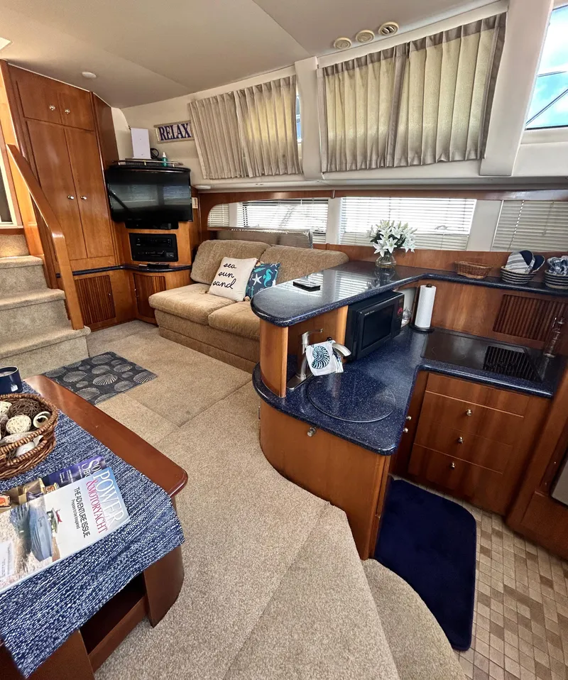 Slide: The Image of 2002 Carver 444 Cockpit Motor Yacht interior with cozy seating and modern amenities. - 19
