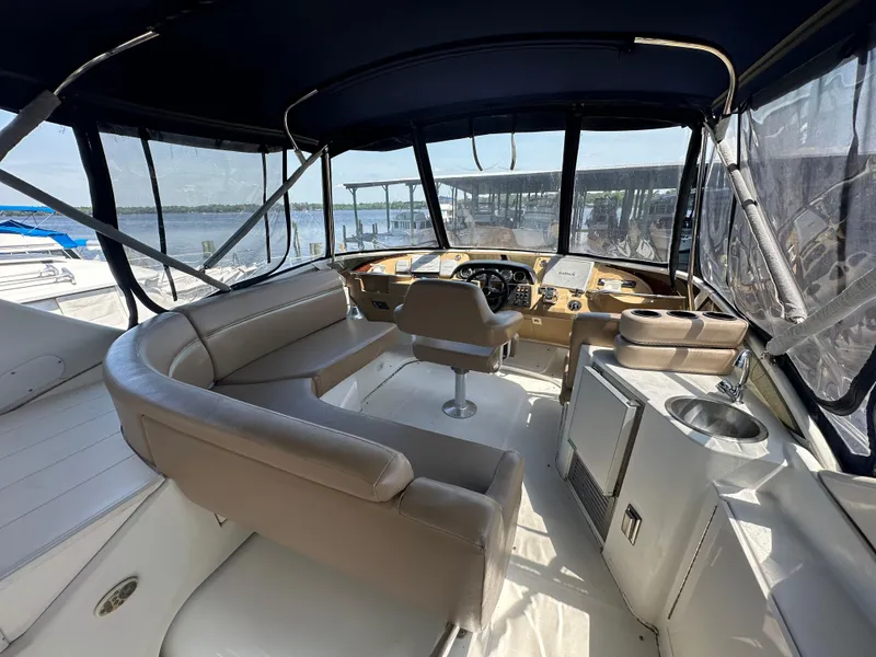 Slide: The Image of 2002 Carver 444 Cockpit Motor Yacht interior with helm and seating area. - 2