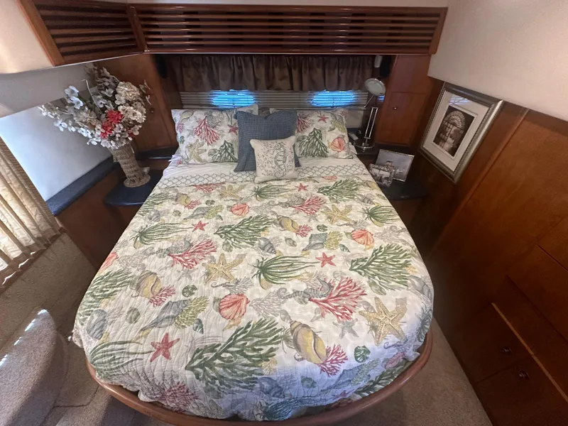 Slide: The Image of Luxurious bedroom in 2002 Carver 444 Cockpit Motor Yacht with floral bedding. - 23